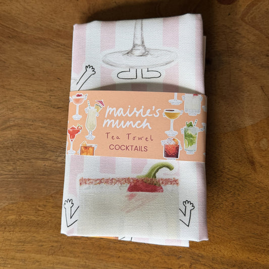 Cocktails tea towel with pink stripes folded in its Maisie's Munch paper band