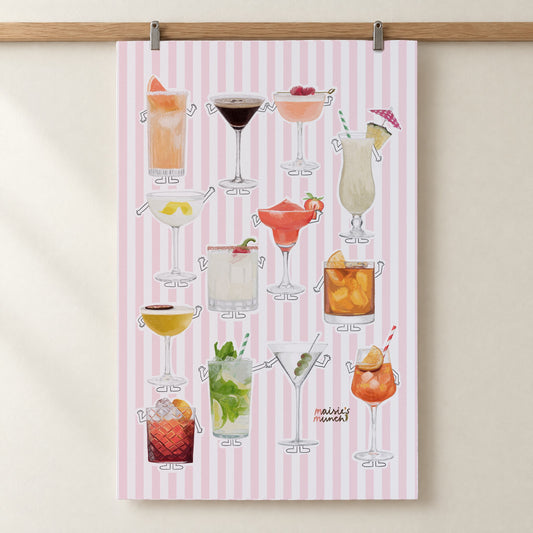 Cocktails tea towel with pink stripes hanging from a wooden rail