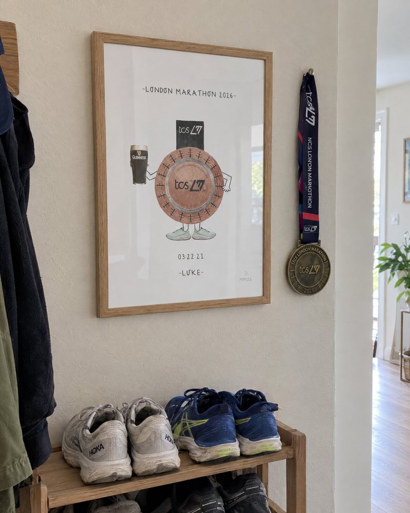 Framed marathon medal print next to the real medal