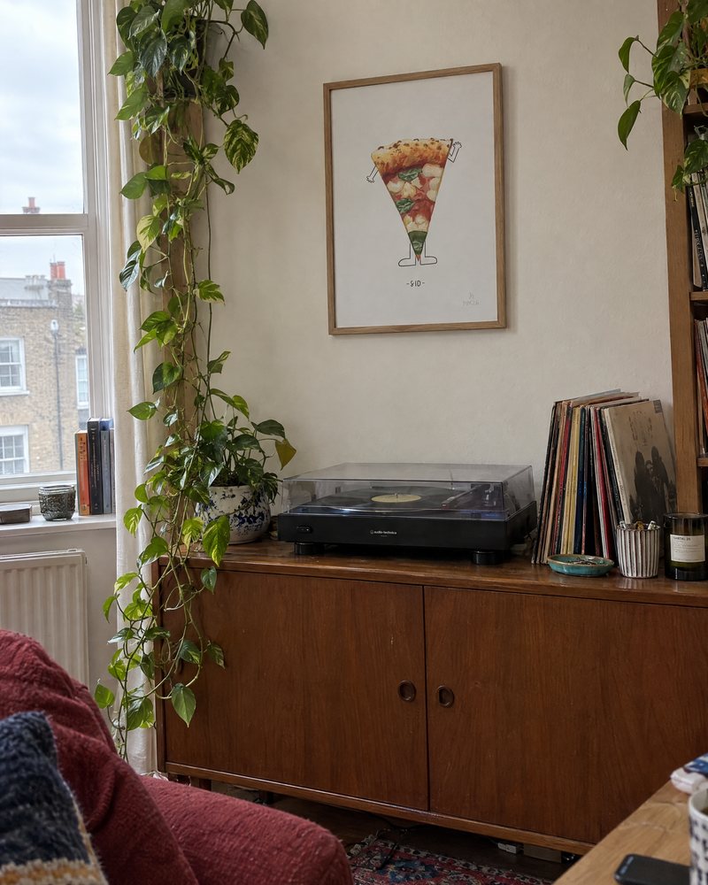 Framed Munch for One print hanging above a record player