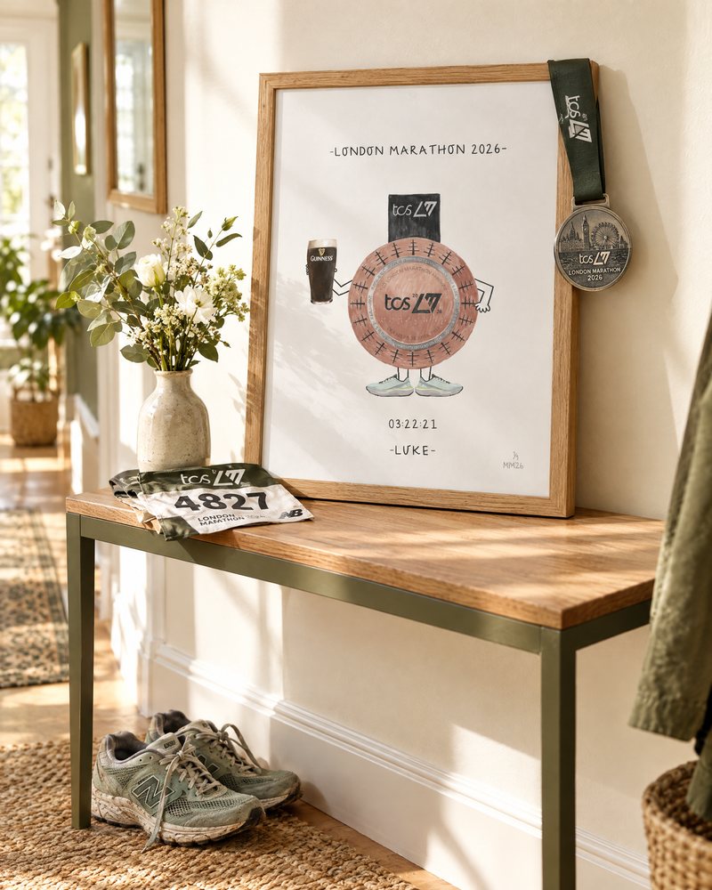 Personalised London Marathon medal drawing on a hallway table with the real medal and trainers
